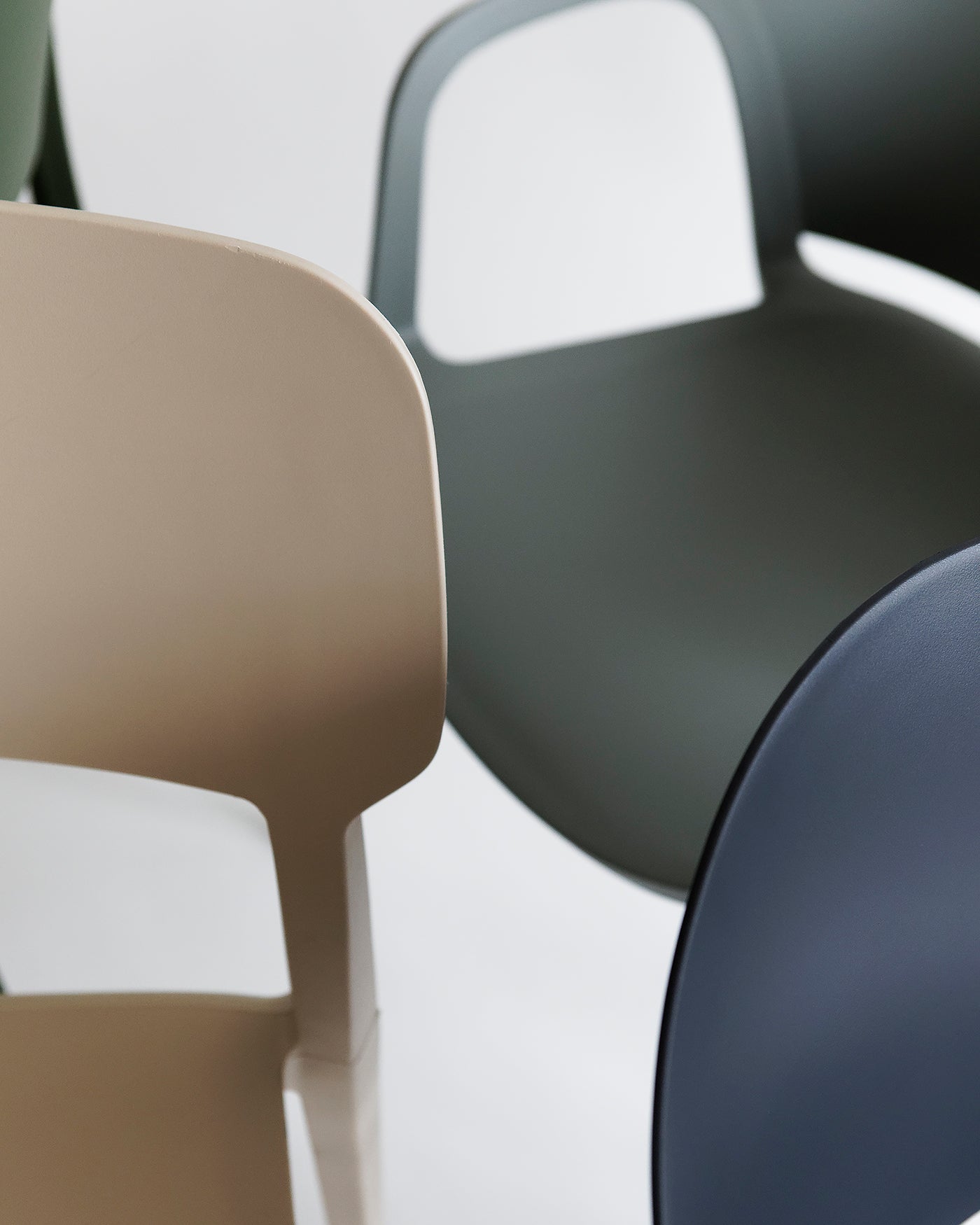Close-up of the Beige Alex Chair showing smooth plastic texture and softly curved backrest for everyday comfort.