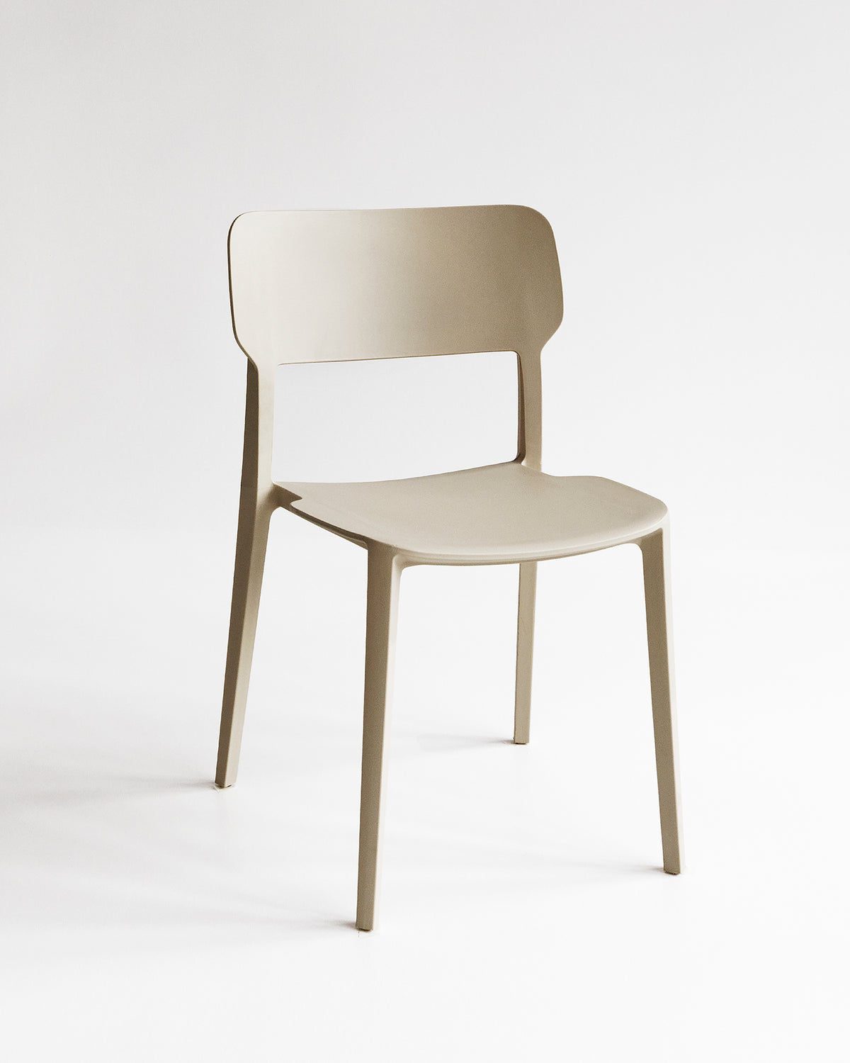 Front view of the Beige Alex Chair, a plastic indoor outdoor dining chair with a curved back and clean silhouette.