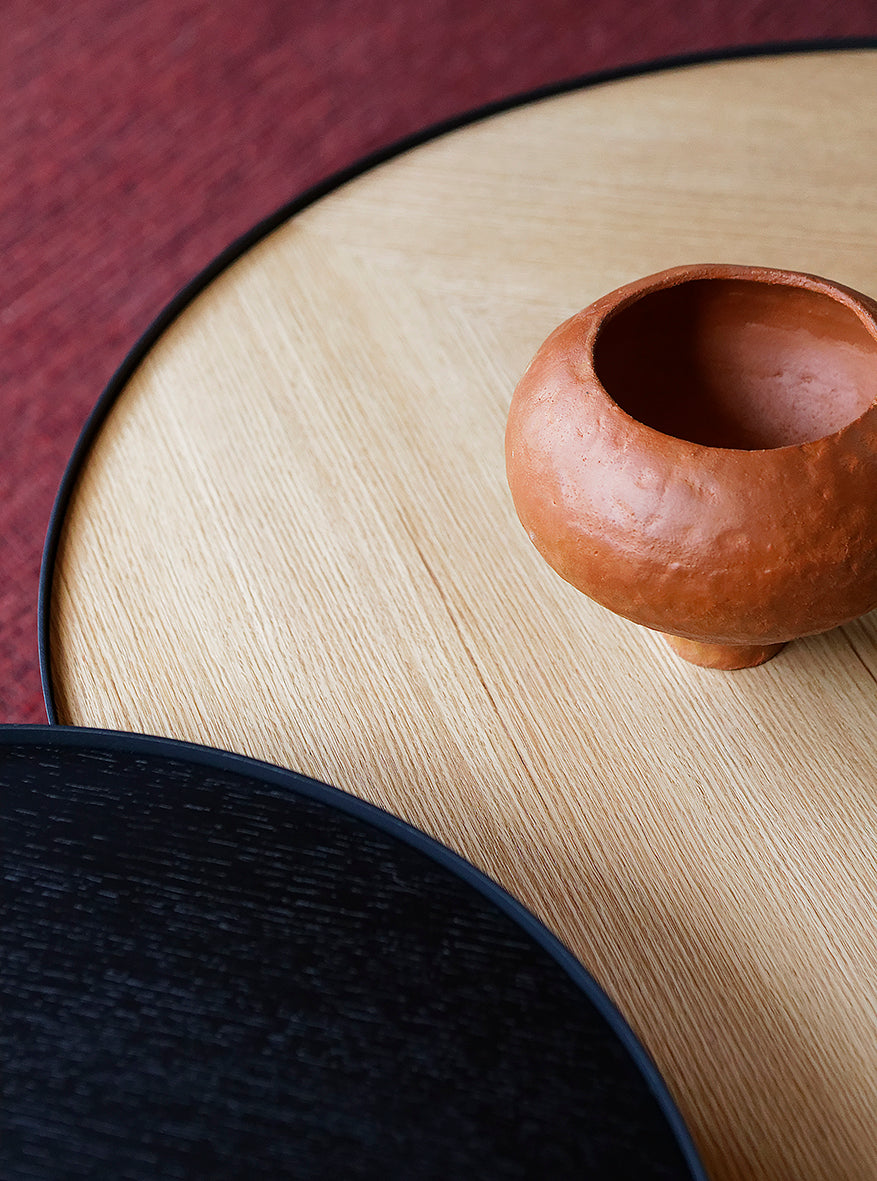 Close-up of the Sia coffee tables showing the deep etched parquetry in both oak and black finishes, highlighting texture and craftsmanship