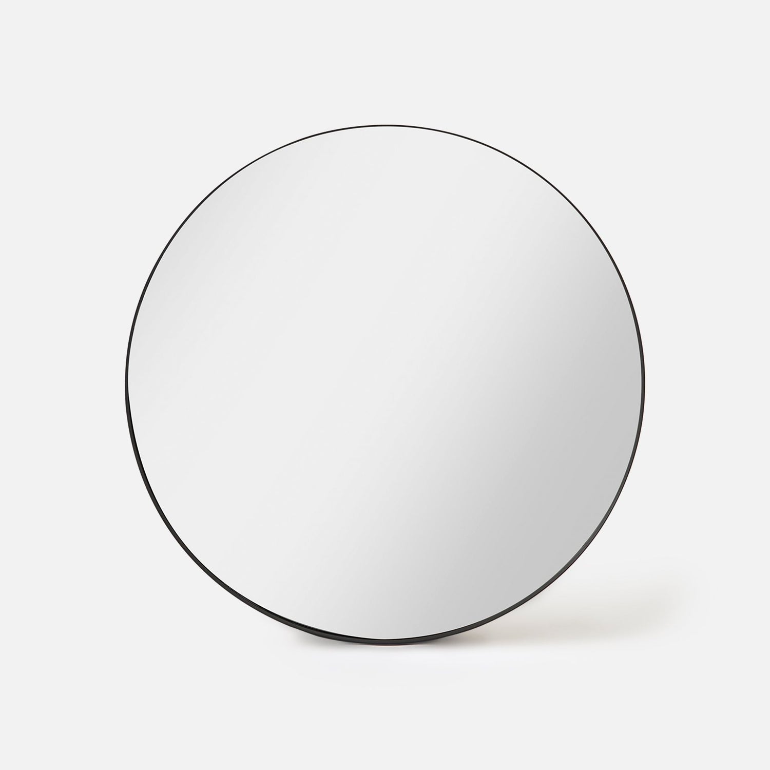 Bobbi Round Mirror in black shown front-on with slim recessed metal frame and one-metre diameter