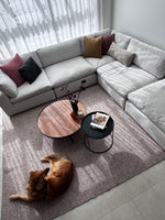Billie modular corner lounge in white fabric styled with a timber coffee table and textured rug