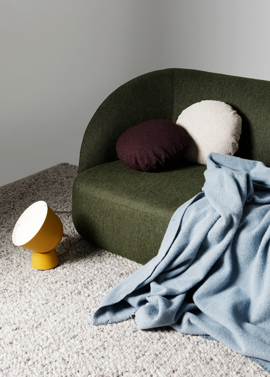 Calvin 2 seat comfortable sofa in olive green fabric styled in a light-filled modern living room