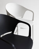 Close-up of the Carla Armchair in Black showing smooth polypropylene finish and ergonomic armrest