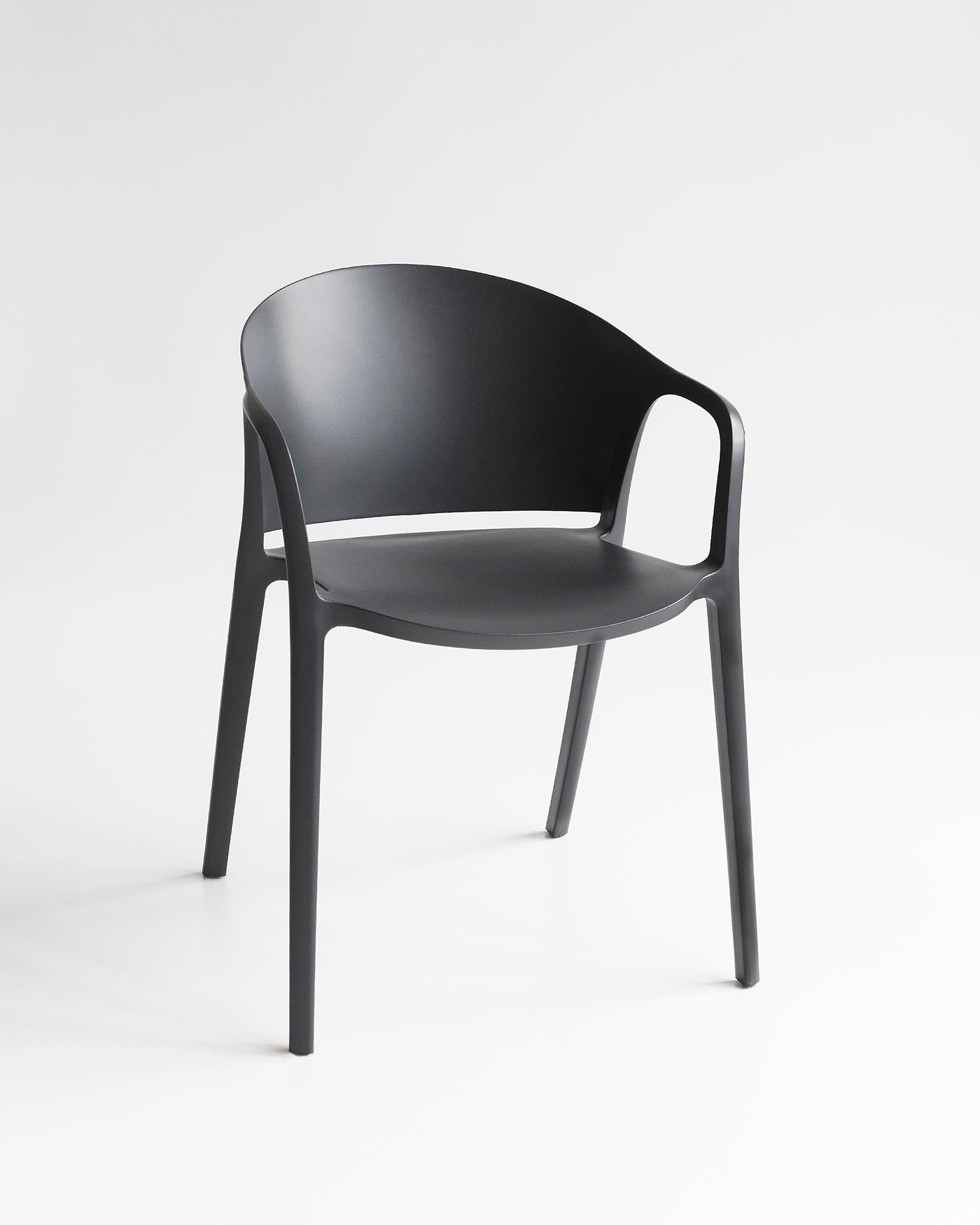 Front view of the Carla Chair in Charcoal with soft curves and tonal matte finish.