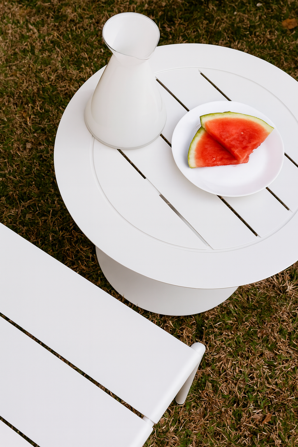 White outdoor side table with watermelon props