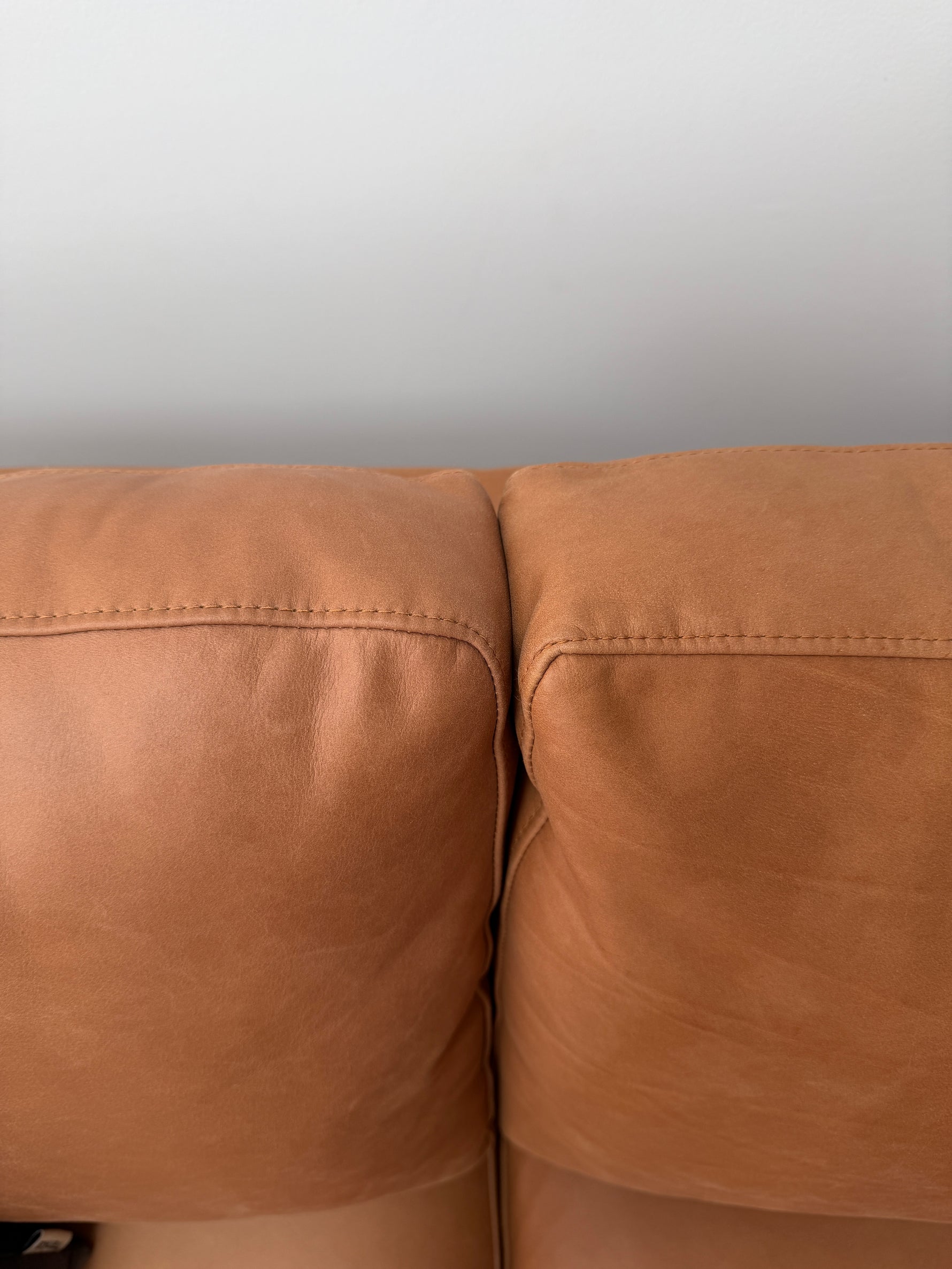 Tan leather sofa showing detail of cushion