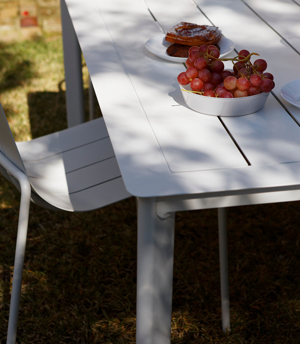 White Estelle outdoor dining table with modern, minimalist design