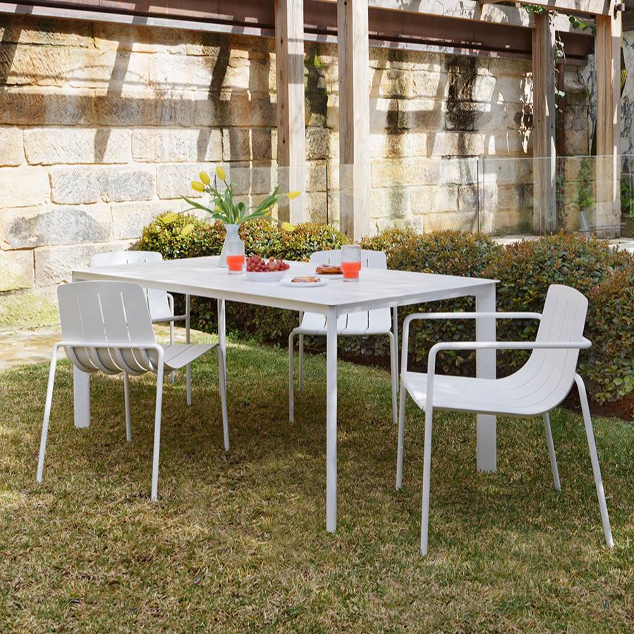 Comfortable white outdoor dining table in a modern alfresco space