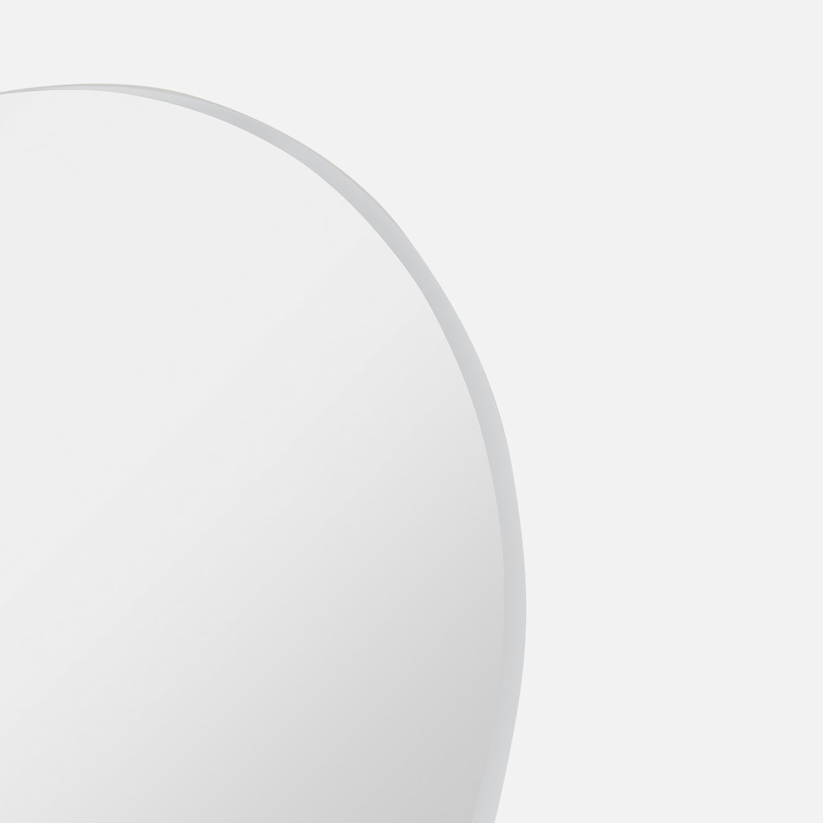 Close-up of the Bobbi Round Mirror in white, showing its slim metal frame