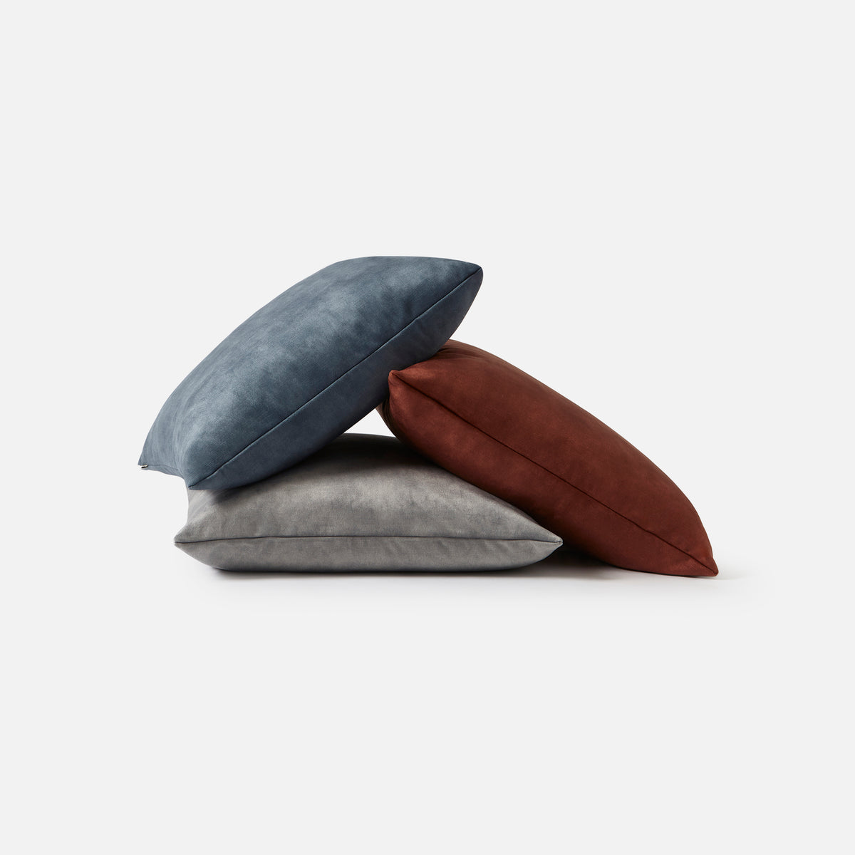 Electra square cushions shown together in their available velvet colourways
