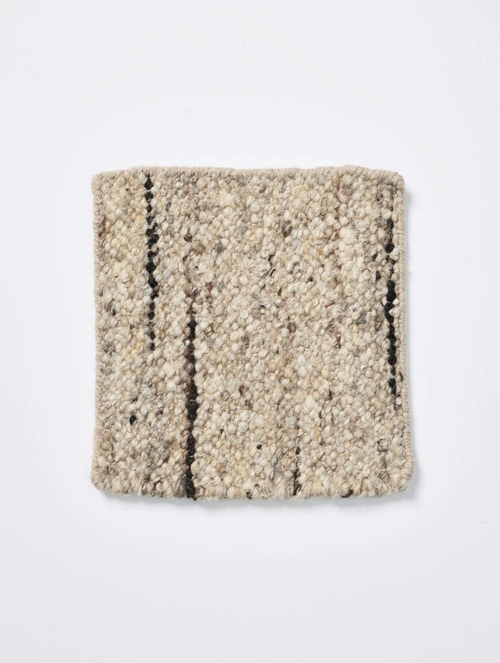 Sample of the Flint Rug by Tribe home shown on a white background