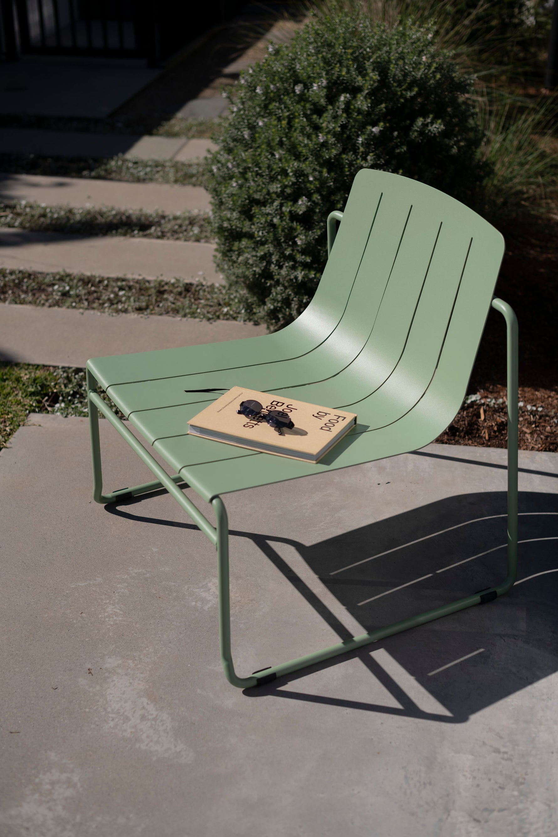 Stylish eucalypt outdoor lounge chair with curved frame and low profile
