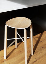 Greta bar stool in oak finish styled in a home kitchen, placed at a timber island bench with natural light and soft tones