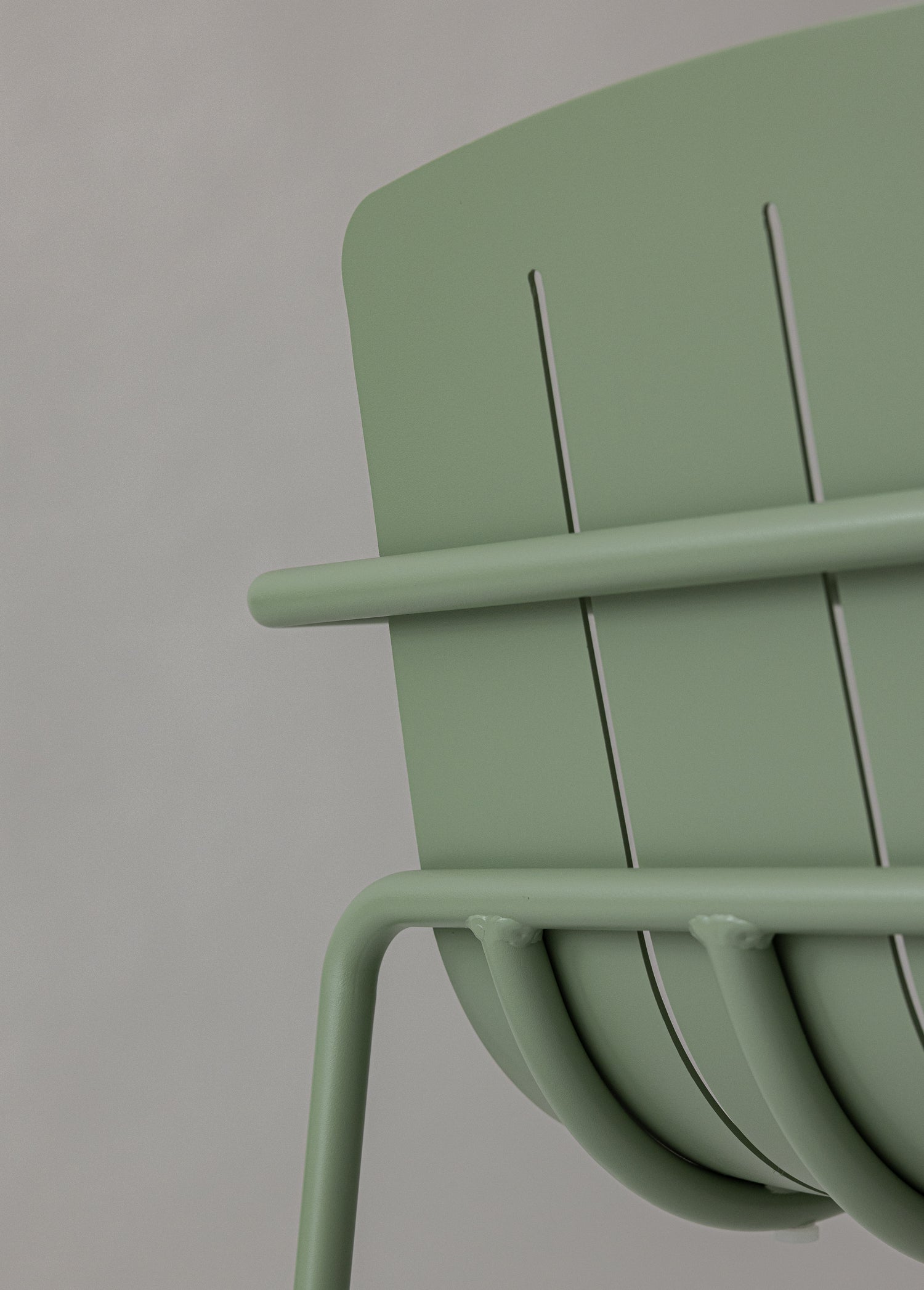 Close-up of a green chair with a neutral background