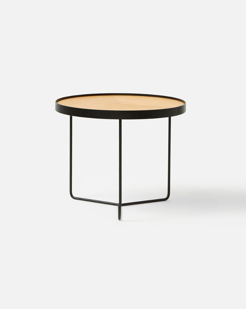 Close-up of the Sia High Side Table in black showing deep etched timber veneer top and powder-coated steel base