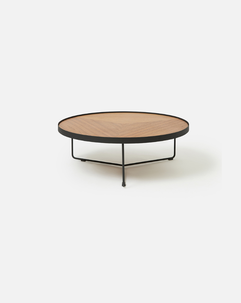 Close-up deep etched detail of the walnut Sia round coffee table showcasing its premium timber veneer finish