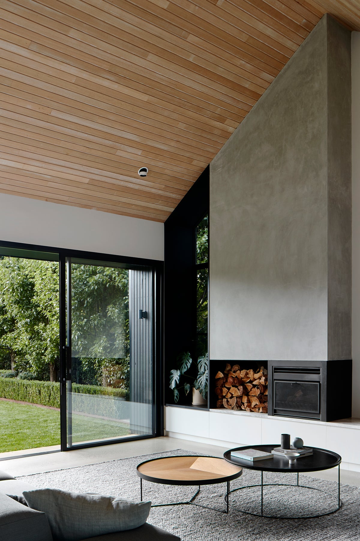 Sia round oak coffee table with deep etched top, styled in a contemporary architectural living space