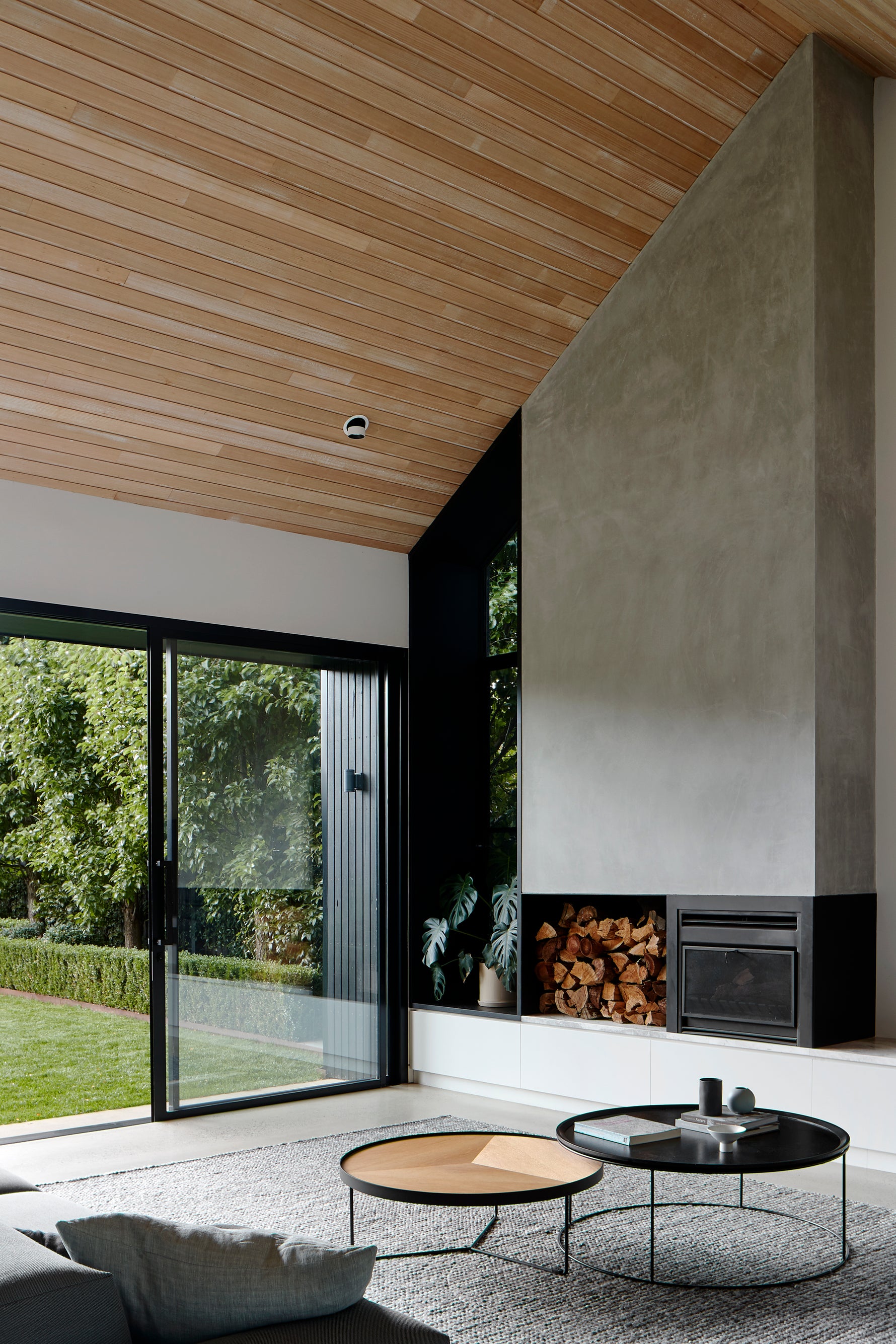 Sia round oak coffee table with deep etched top, styled in a contemporary architectural living space
