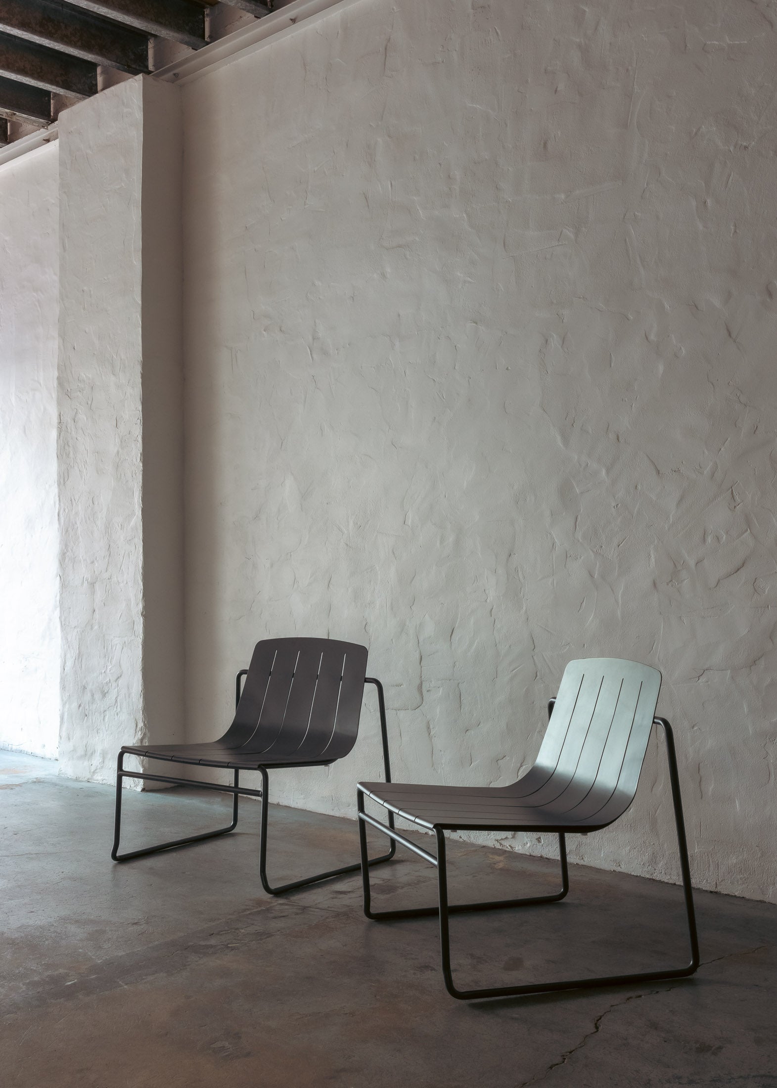 Two Frankie outdoor lounge chairs in charcoal styled in a cosy, sheltered alfresco nook
