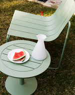 Eucalypt Frankie outdoor lounge chair with Carmen side table in a relaxed garden setting