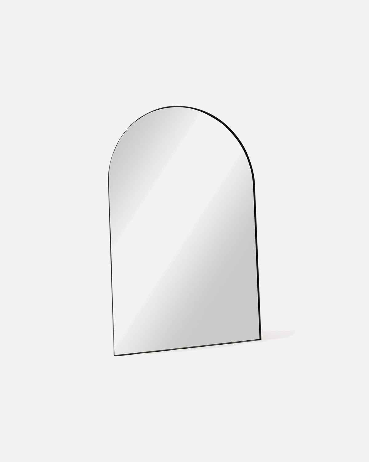 Archie Oversized Mirror in black shown at an angle, showing the depth of its metal frame