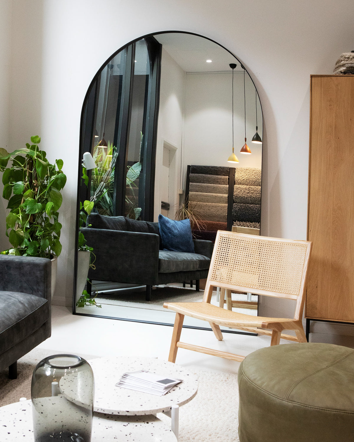 Archie Oversized Mirror in black displayed in a showroom setting