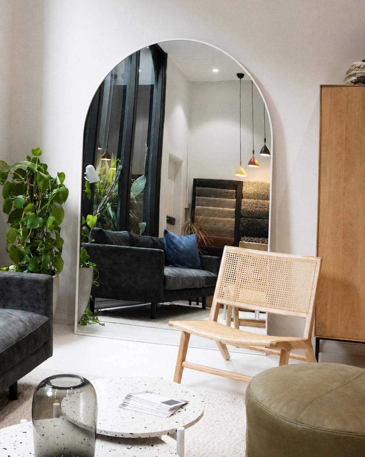 Archie Oversized Mirror in white leaning in a lounge room setting