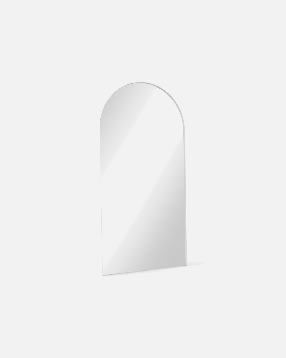 Archie Standard Mirror in white shown at an angle, showing the depth of its metal frame