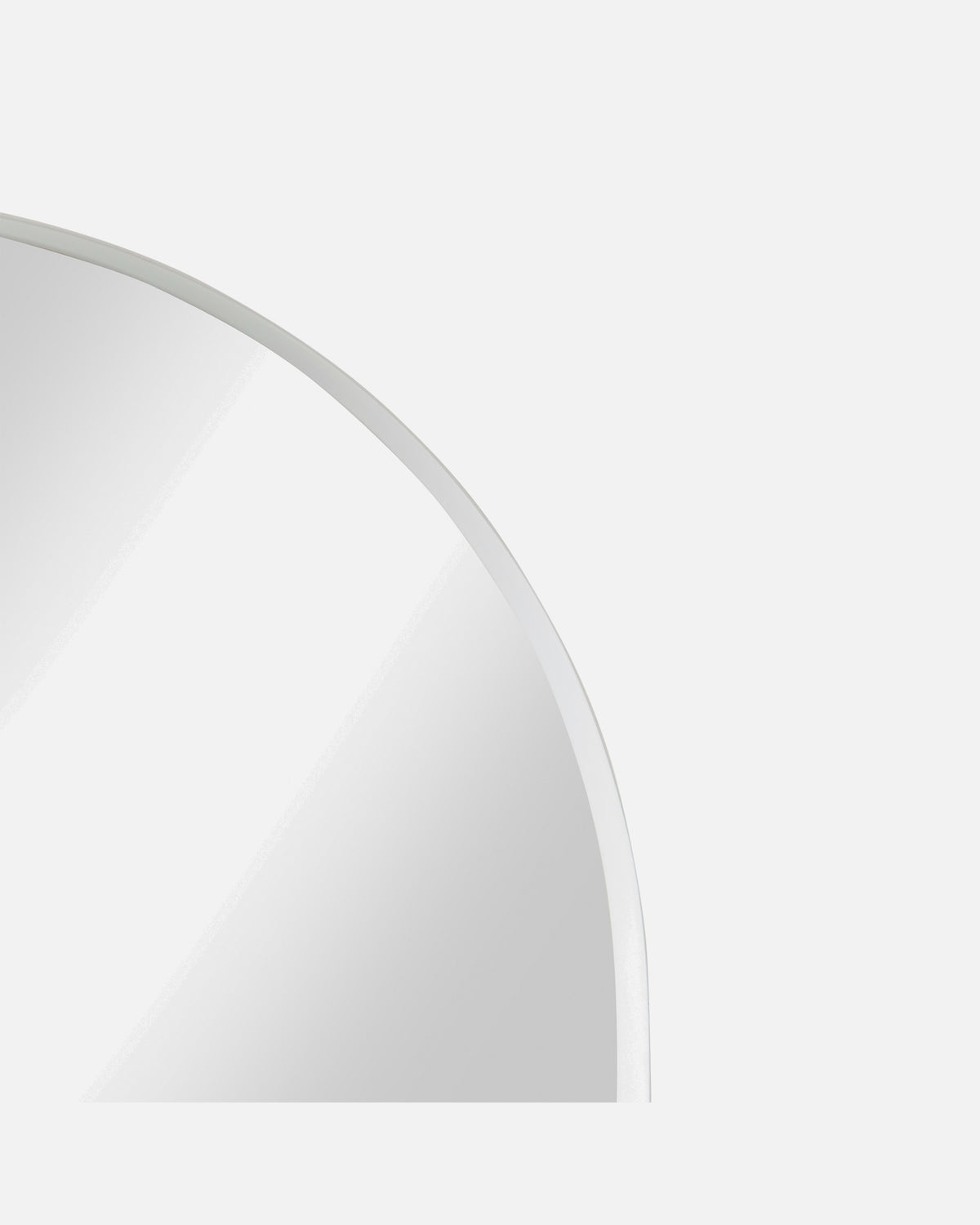 Close-up of the Archie Standard Mirror's arched corner and slim white metal frame