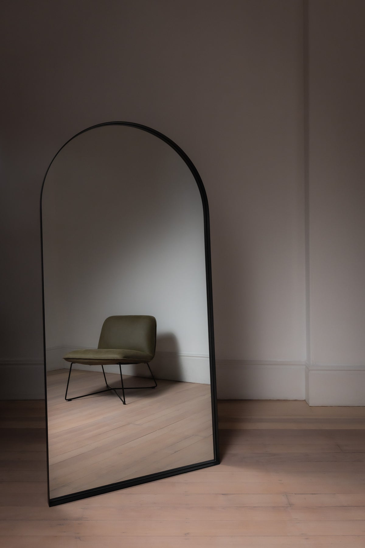 Black Archie Arch Mirror in a minimal room, large full length mirror reflecting neutral décor