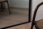 Close-up of the black Luca Mirror corner showing powder-coated finish