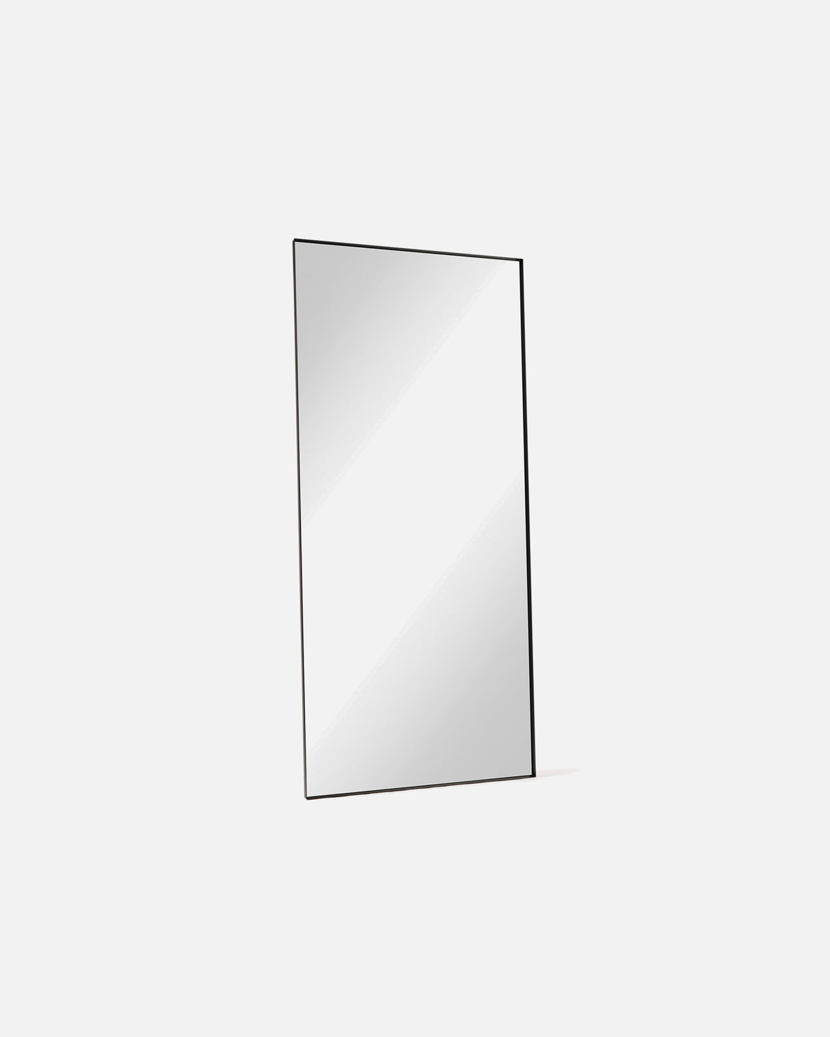 Luca Oversized Mirror in black shown at an angle, showing the depth of its metal frame