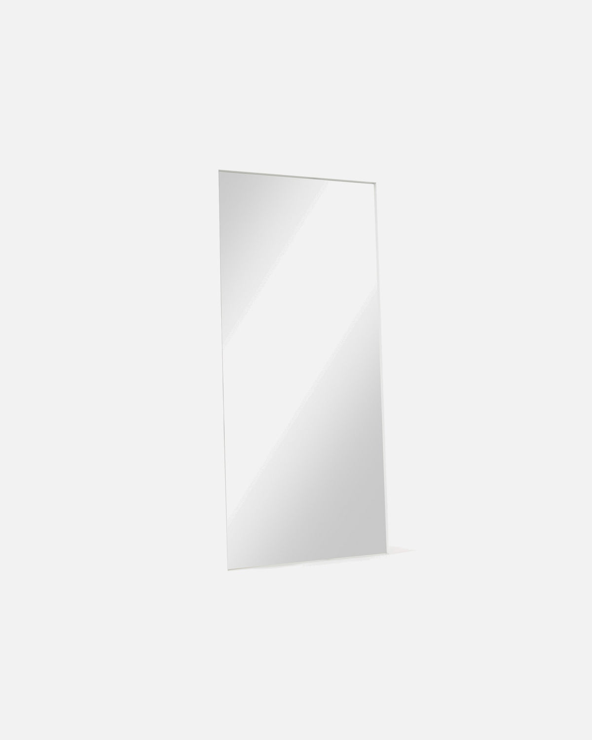 Luca Standard Mirror in white shown at an angle, showing the depth of its metal frame