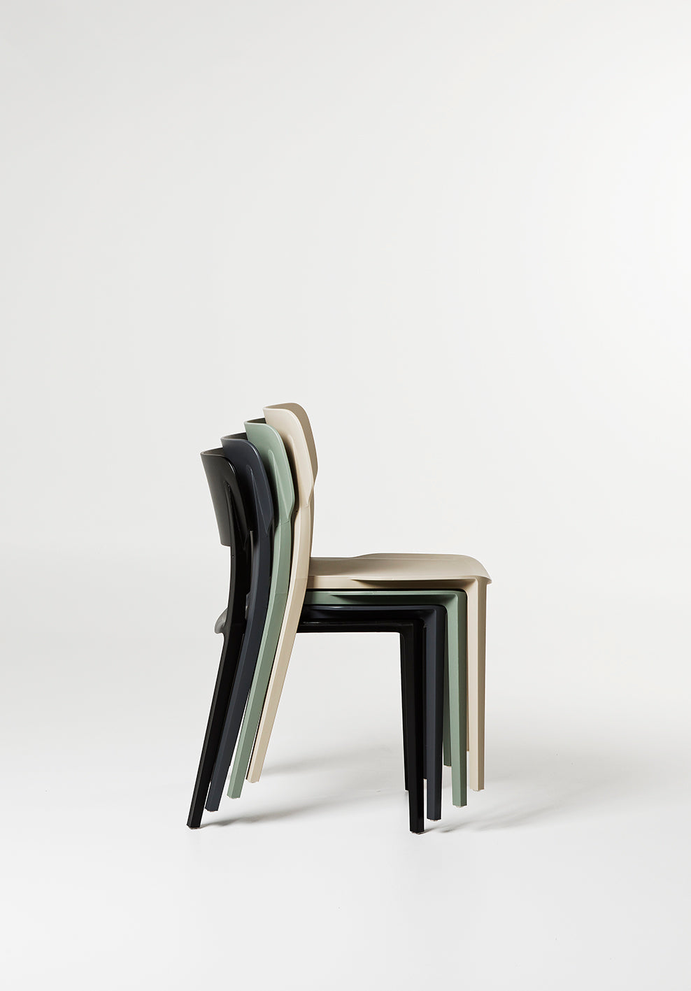 Alex Chairs stacked neatly – space-saving, stackable plastic dining chairs ideal for indoor and outdoor use. Durable, lightweight, and perfect for flexible seating in homes or hospitality spaces.